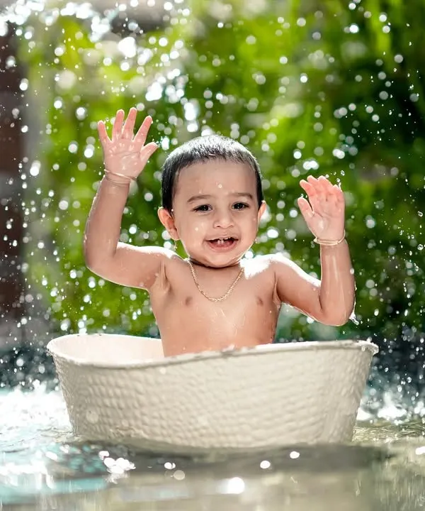 Pure happiness in a splash! This little one is having the time of his life in our water tub, creating a perfect action shot.