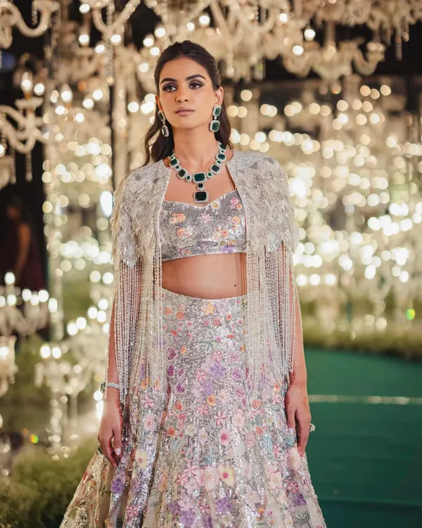 This Rahul Mishra runway piece was love at first sight for Manisha's sangeet. The floral embroidery paired with a feathered and beaded cape is the definition of a showstopper look.