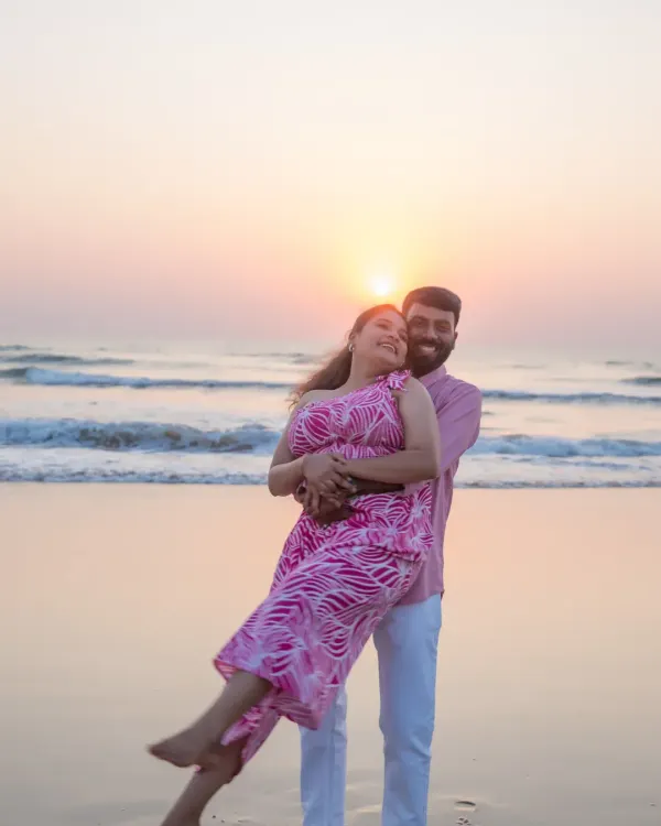 A playful and romantic pre-wedding moment as the sun sets over the ocean. Beach photoshoots like this are a wonderful way to capture your love in a relaxed, natural setting before the big day.