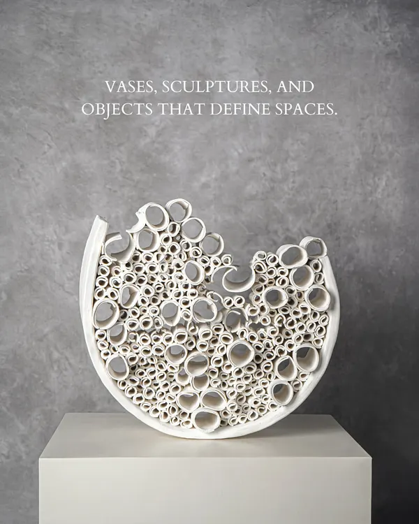 This intricate white ceramic sculpture is a testament to artistry. Its complex, cellular structure creates a captivating play of light and shadow, making it a defining object for any modern space.