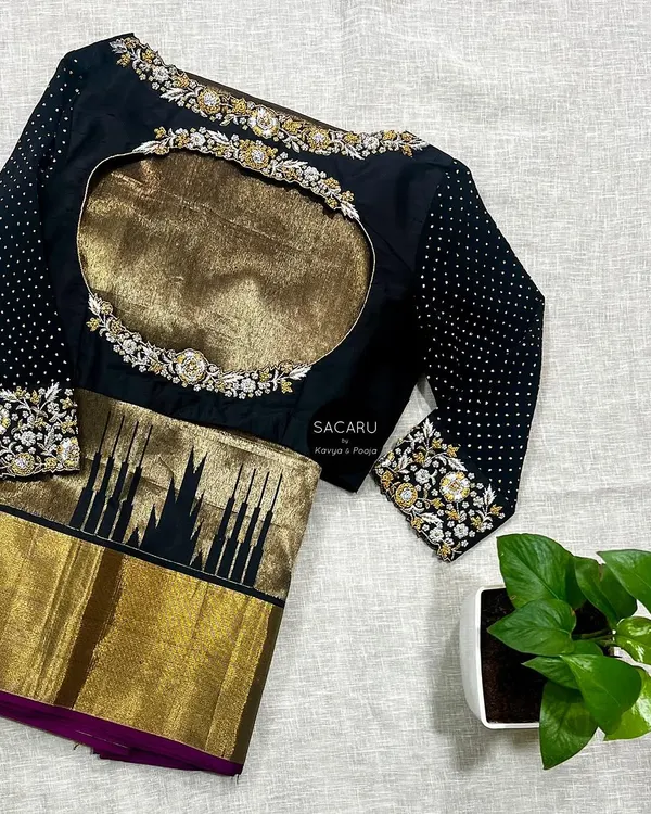 Gold, silver, and black make for a timeless combination. We designed this black silk and georgette blouse with gold and silver zari hand embroidery to pair with a classic Kanjeevaram saree.