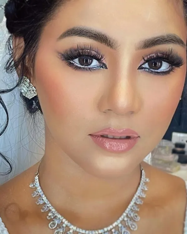 This Arabic bridal look is defined by its bold eyes. I used a set of full volume eyelash extensions to create a dense, fanned-out lash line that complements the dramatic winged eyeliner and bright inner corner highlight.