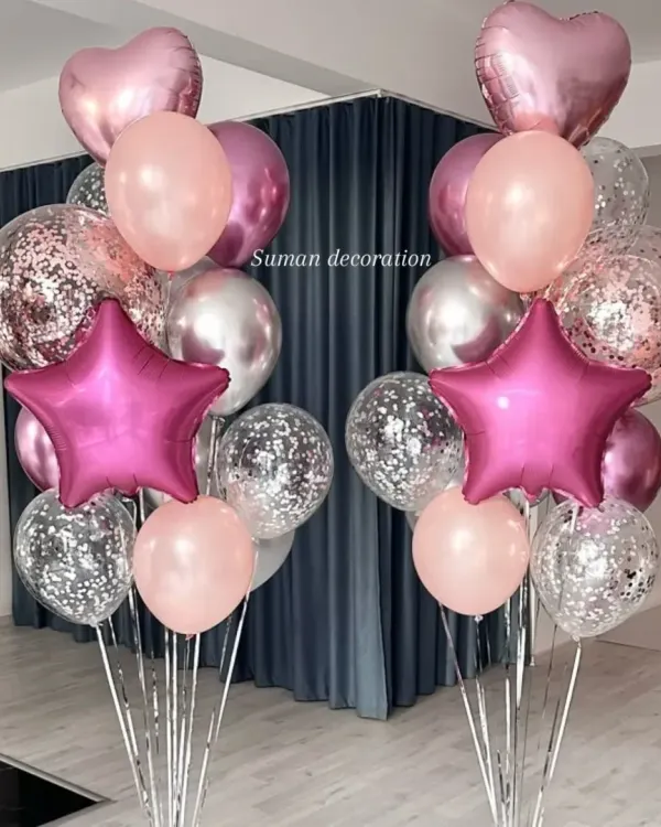 Two matching balloon bouquets perfect for flanking a doorway or cake table. These feature pink foil stars, confetti balloons, and chrome silver and pink latex balloons.