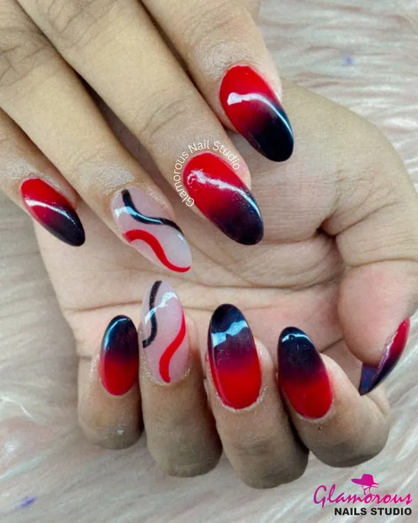 This design is for those who love a dramatic look. We created a striking ombré effect, blending a fiery red into a deep black. The abstract line art on the accent nails adds a modern, graphic touch to this bold set.