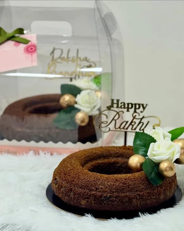 Rakhi is here, and so are my exclusive hampers! This image showcases a rich brownie tower and a wholesome whole-wheat jaggery cake, perfect for celebrating the sweet bond between siblings.