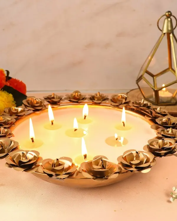 Our stunning Rose Urli candle bowl, featuring multiple wicks surrounded by delicate metal roses. This piece makes an epic centerpiece and a truly memorable gift for any celebration.