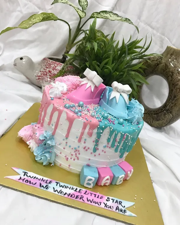 From pastel dreams to tiny booties, my baby shower cakes are as special as your celebration. This gender reveal cake features pink and blue drips, sprinkles, and adorable fondant baby shoes.