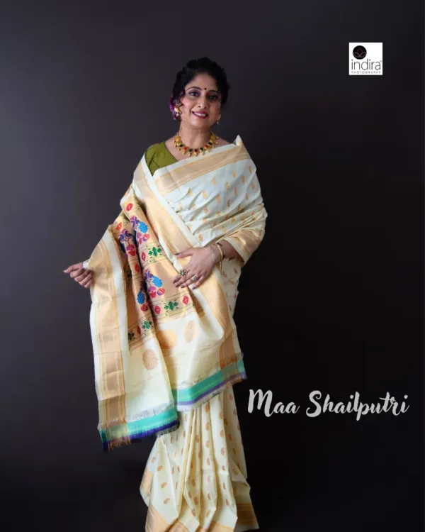 We began the Navdurga series with Maa Shailputri, representing purity and innocence in this beautiful white Paithani saree. This studio portrait uses a simple dark background to let the intricate details of the saree and the subject's graceful pose shine.