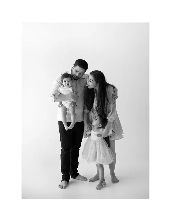 This is what it's all about. A quiet moment in my studio with nothing but family, love, and simple, honest connection. This black and white family portrait captures the tenderness between parents and their little ones.