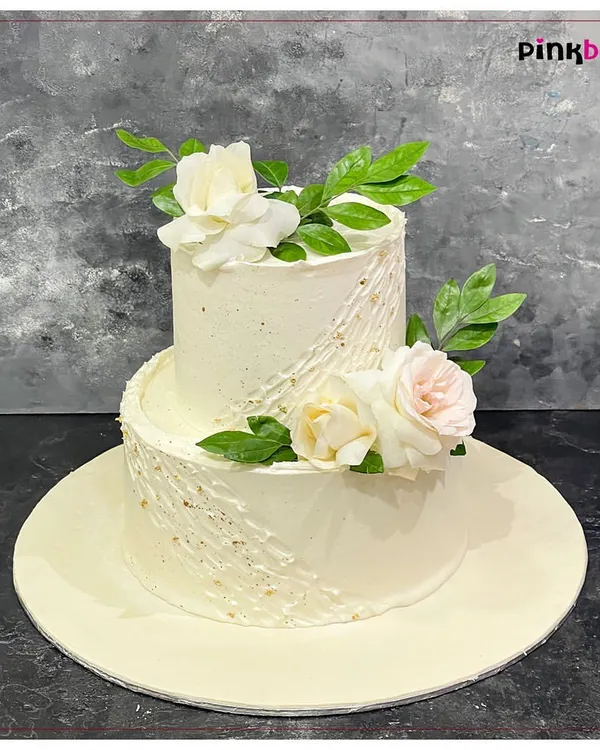 This two-tiered cake with fresh, delicate white and pink roses is one of our favorite designs for engagements and anniversaries. We work with you to create an elegant centerpiece that is just as beautiful as it is delicious, and always 100% eggless.