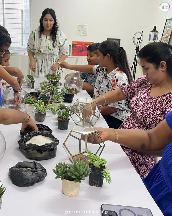 A table full of aspiring gardeners! Our terrarium workshop is a crowd favorite, where participants create their own miniature succulent gardens in beautiful glass bowls.