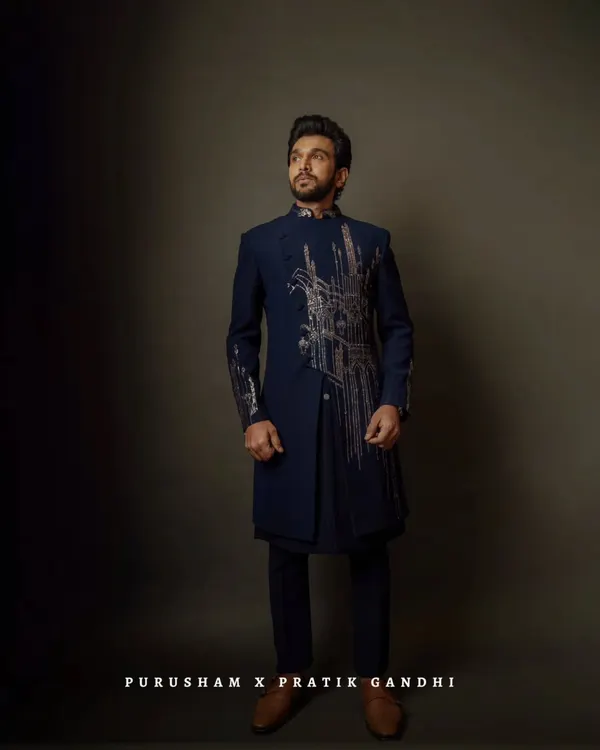 With my tailored precision, Pratik Gandhi proves that style is the ultimate power move. This asymmetrical navy bandhgala with architectural embroidery makes a strong, confident statement.