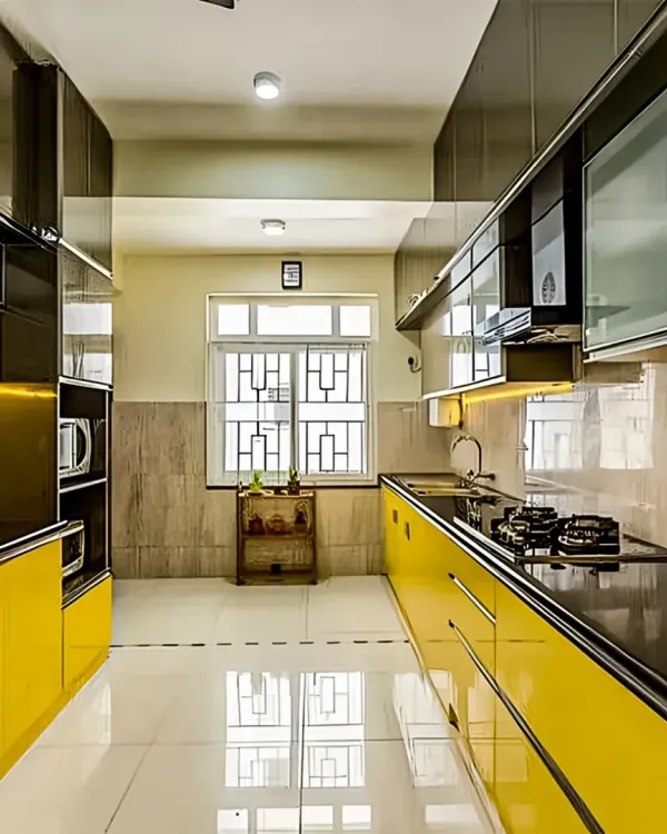 This parallel kitchen makes a bold statement with vibrant yellow high-gloss cabinets. The layout maximizes storage and counter space on both sides, while the reflective surfaces make the galley feel wider.