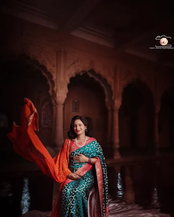 This portrait captures the divine elegance of motherhood. I used dramatic lighting in my studio to highlight the rich textures of this beautiful saree and the ornate backdrop, creating a timeless image that feels like a classic painting.