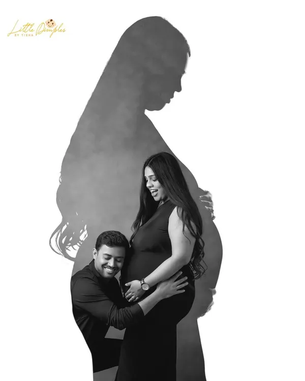 A creative black and white portrait using shadows and silhouettes. This artistic shot of a couple is a unique and powerful way to capture the moment.