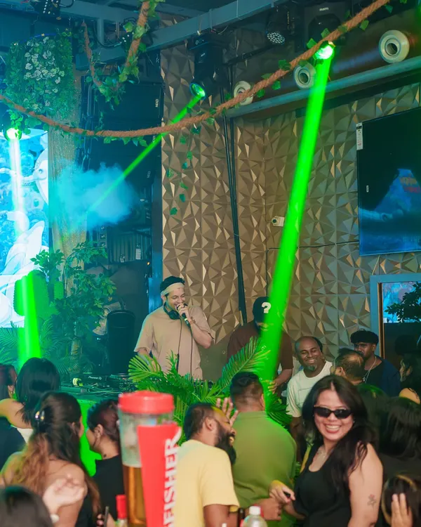 Here I am on the mic at Happy Brew, with the green lasers setting the mood. The vibe here is always electric, especially on a Thursday ladies' night.
