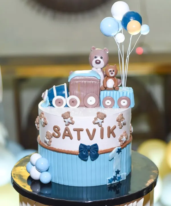 A close-up of an adorable teddy bear and train themed birthday cake for a little boy named Satvik. We capture the artistry of your custom birthday cakes.
