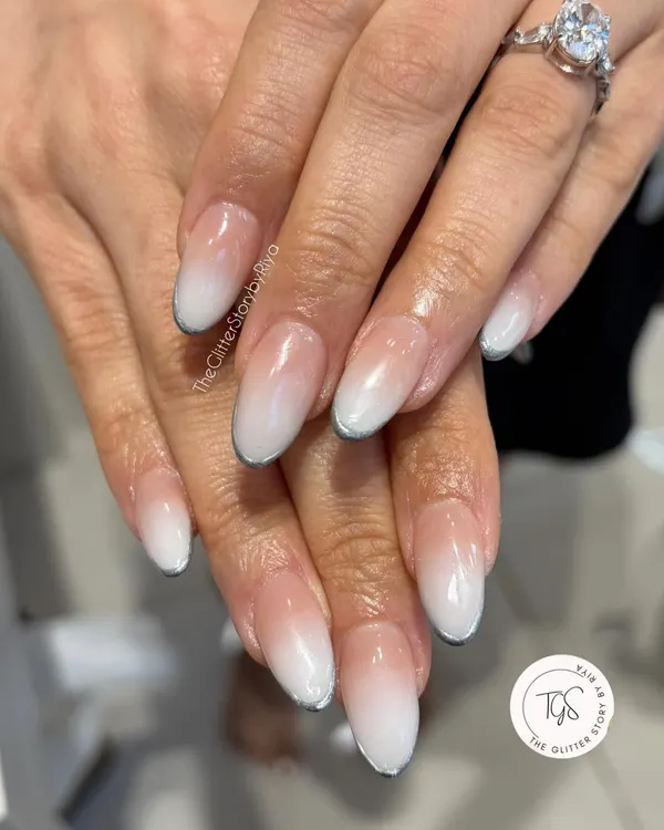 A flawless baby boomer or ombré nail set. The seamless transition from a nude base to a soft white tip is a timeless and elegant choice for any occasion.