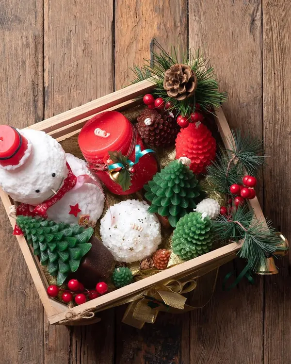 This is what a truly special Christmas gift looks like. I filled this wooden hamper with some of my favorite festive creations, including a hand-poured snowman candle, pinecone candles, and detailed Christmas tree candles.