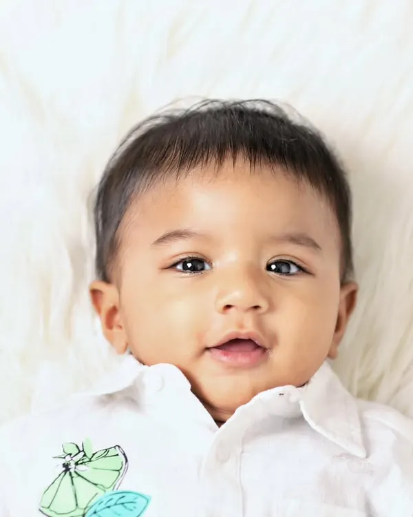A beautiful close-up portrait of one of the twin boys from a six-month milestone session. Capturing individual shots is just as important as capturing them together.