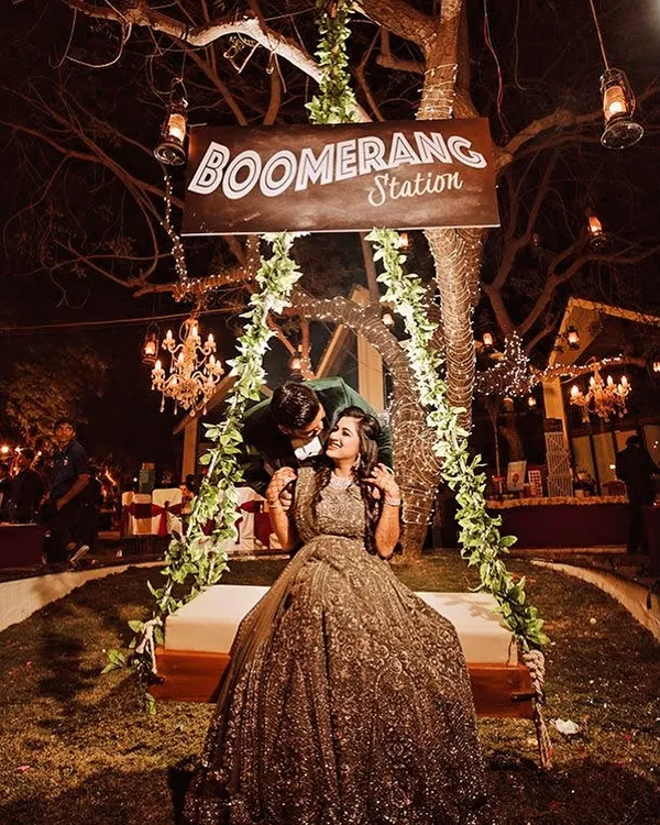 Creating the perfect photo moment is part of the job. This "Boomerang Station" swing, wrapped in fairy lights and set against a backdrop of chandeliers, was a huge hit at this wedding reception.