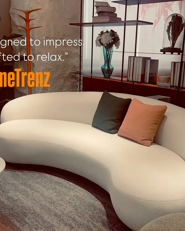 Designed to impress, crafted to relax. This custom curved sofa in a textured white fabric acts as the centerpiece of the living room, offering both style and supreme comfort.