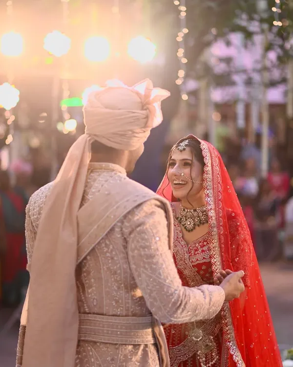 A candid moment of pure happiness between the bride and groom. Her makeup was designed to look radiant and fresh even in the soft evening light, with a focus on glowing skin and defined eyes.
