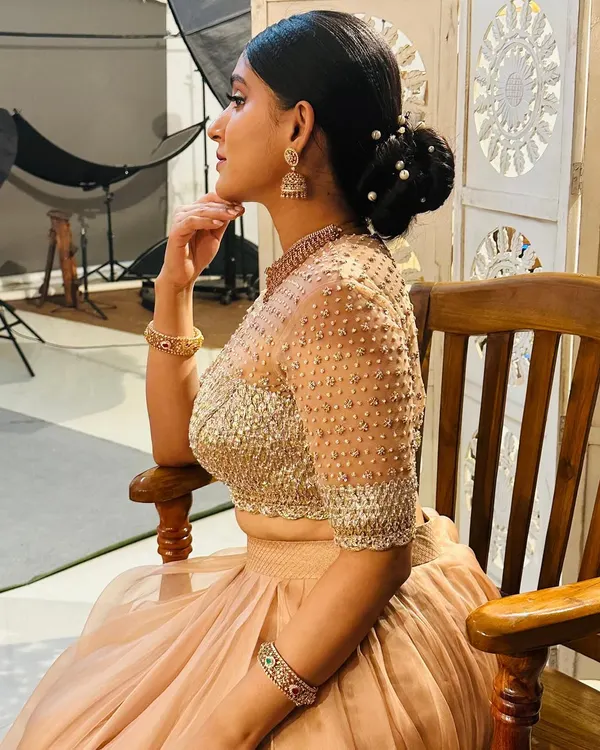 Akanksha is glowing in this custom organza layered skirt and gotta blouse. The blouse features a gotta patti patch embossed into the fabric, which is further uplifted with zari, zardosi, beads, and sequins.