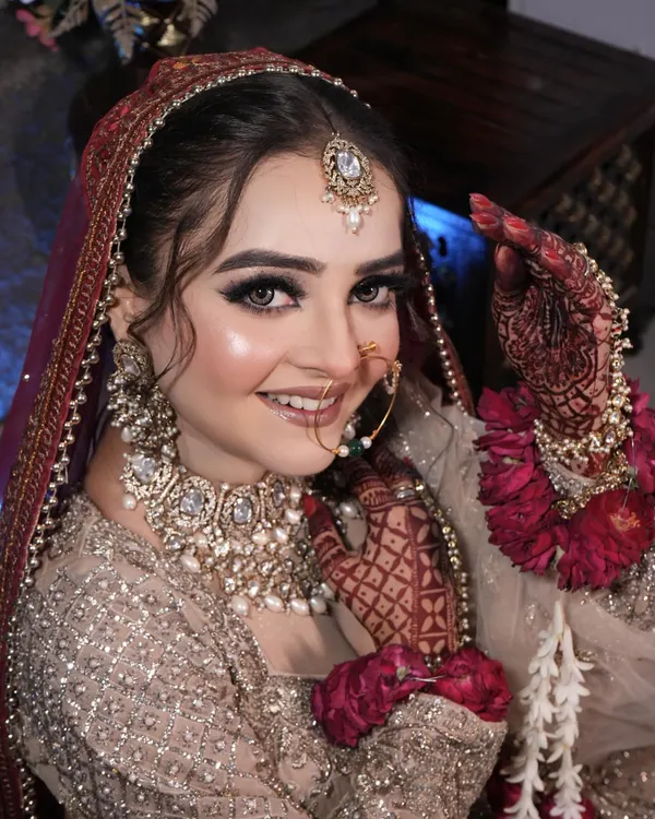 This is the look every bride dreams of. I focus on creating a flawless, radiant base with captivating eyes and a perfect lip color, ensuring you look and feel absolutely stunning on your wedding day. This is a classic example of my signature bridal makeup.