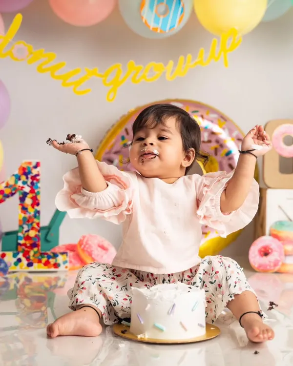 This is what pure first-birthday joy looks like. We love capturing these wonderfully messy, unscripted cake smash moments where your baby's personality shines through.