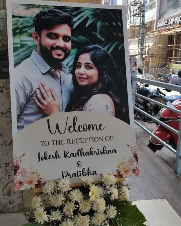 For this wedding reception in JP Nagar, I designed a clean and elegant welcome sign featuring a lovely photo of the couple. Placed at the entrance with a simple floral arrangement, it warmly greeted all the arriving guests.