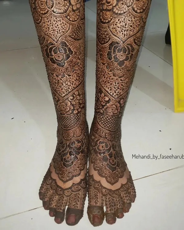 A full bridal leg design, featuring intricate patterns that extend from the toes up to the shins.