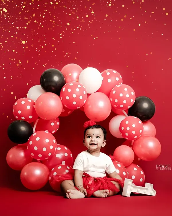 We believe every birthday is magic, and this vibrant setup with a balloon wreath captures that first-year sparkle. This is one of our most popular first birthday photography themes, creating a perfect, joyful centerpiece for your baby's milestone.