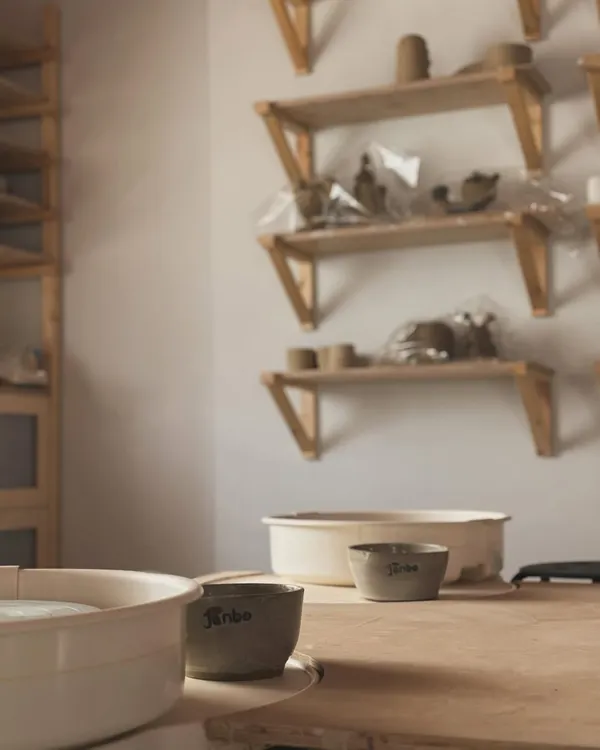 A quiet corner of my studio. The pottery wheel, some water bowls, and shelves of works-in-progress. This is where I come to find my peace and create.