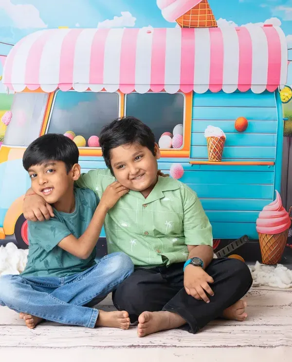 Summer fun with an ice cream themed mini session. This colorful and playful setup is perfect for capturing the sweet smiles of siblings.