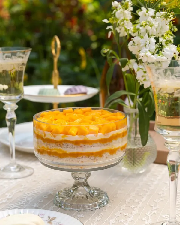 Summer in a bowl. My Mango Cream Cheese Trifle is layered with soft cake, light cream, and heaps of fresh, sweet mango.