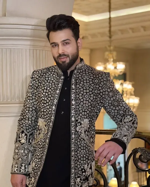 This is one of my signature pieces, a bespoke black sherwani featuring an intricate, geometric silver embroidery pattern. The detailed craftsmanship makes it a standout choice for a groom looking for a royal yet contemporary wedding outfit.