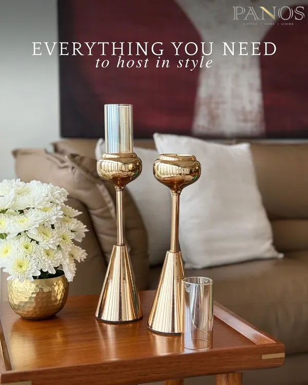 Our Vesper candle holders, with their sleek golden form, are paired with a matching hammered gold vase. This set is designed to bring a cohesive and luxurious touch to any side table or console.