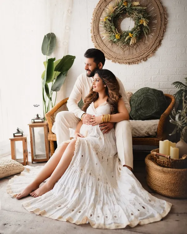 A picture of pure bliss in my favorite boho setup. This couple is surrounded by natural textures and warm light, creating a serene and romantic maternity portrait.