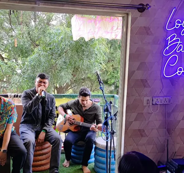 A beautiful moment from a Loysum Balcony Concert. You can see the intimate setup, with artists performing on the balcony for a small audience. It's all about togetherness and the joy of music.