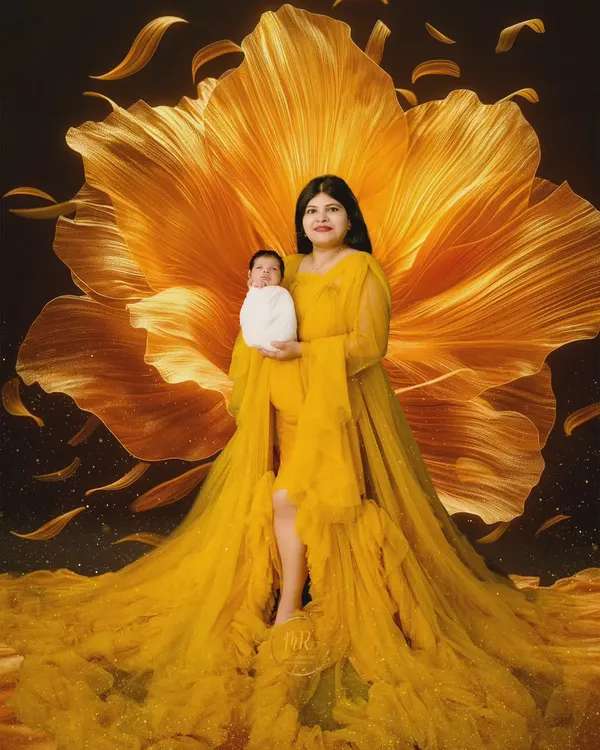 A breathtaking fine-art portrait of a mother and her newborn. I used a dramatic yellow gown and a large floral backdrop to create this vibrant and artistic image.