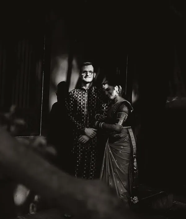 A dramatic black and white portrait of a couple, the shadows and light creating a timeless, artistic feel.