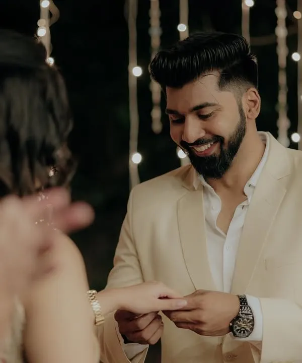 The exact moment he places the ring on her finger, a priceless memory captured forever during their engagement ceremony.