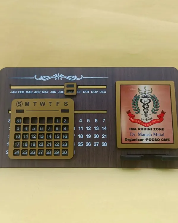 This infinity calendar is a fantastic corporate gift. It features a perpetual calendar, a phone stand, and a customizable plate where I can add your company or event logo, like this one for the IMA Rohini Zone.