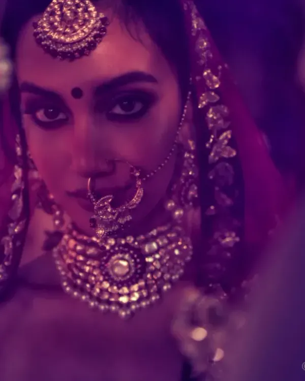 This is the hero image. A single frame from a bridal couture film, capturing the quiet intensity and rich detail that defines our cinematic approach. We used atmospheric lighting to create a mood that feels both timeless and modern for couturier Shyamal & Bhumika.