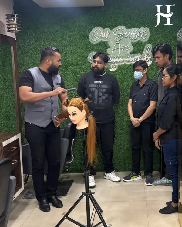 Here is our National Technical Head, Mr. Mahesh Gore, conducting a hands-on training session. Our students learn directly from experts, practicing techniques on mannequins to perfect their craft.