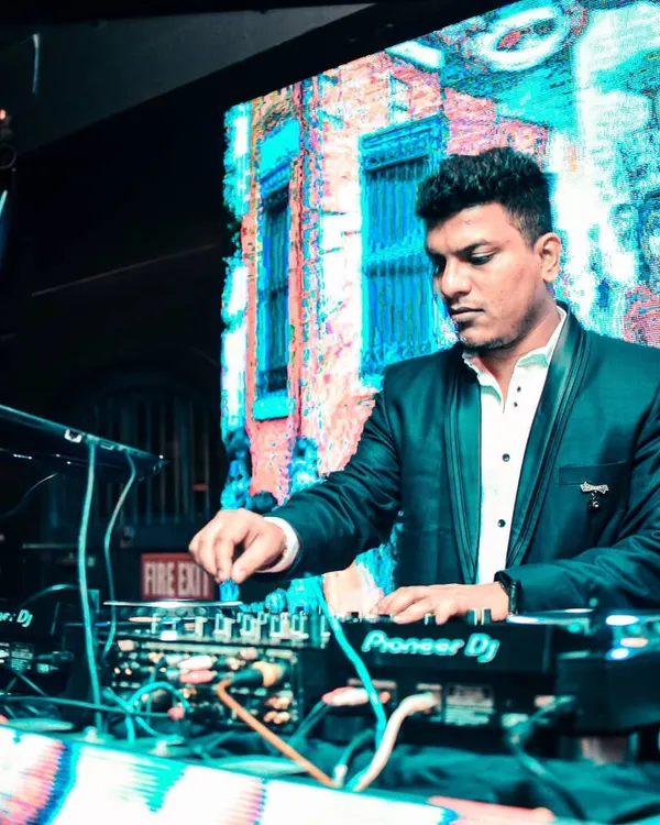 This is where the magic happens. Here I am delivering a full audio-visual DJ set, mixing tracks and live visuals on the big screen to create an unforgettable party experience.