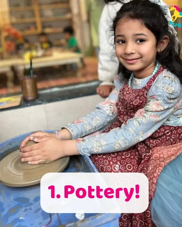 A young artist finds her focus at the pottery wheel. This activity is wonderful for building concentration and patience, as children learn to shape the clay with gentle, steady hands.