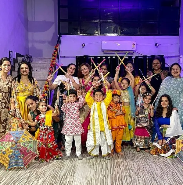 Our Dandiya Nights are where tradition meets celebration. This group photo captures the joy of our members, both adults and kids, dressed in colorful traditional attire, ready to dance with dandiya sticks.