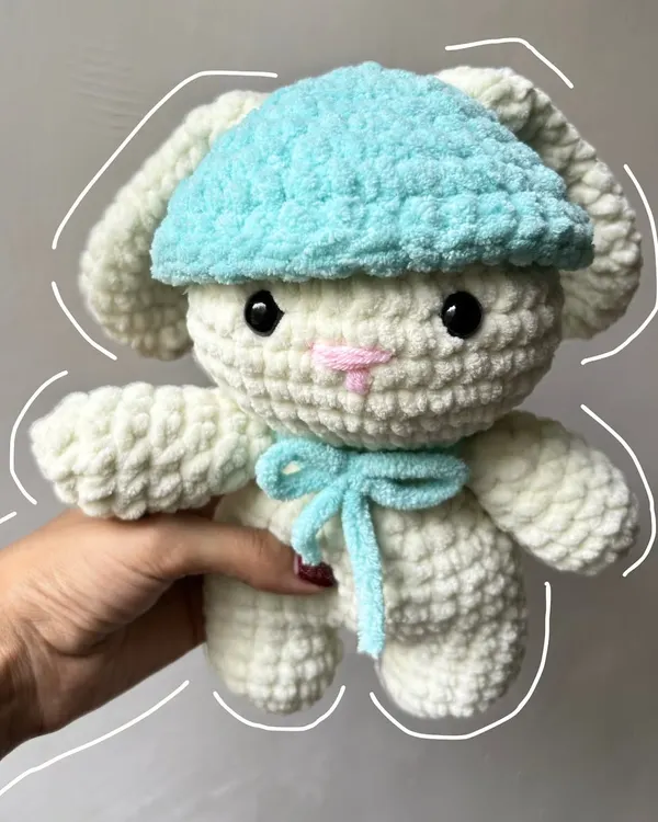 This fluffy crochet bunny plushie is made with super soft velvet yarn, making it extra cuddly. The little blue hat and bow add a touch of cuteness.